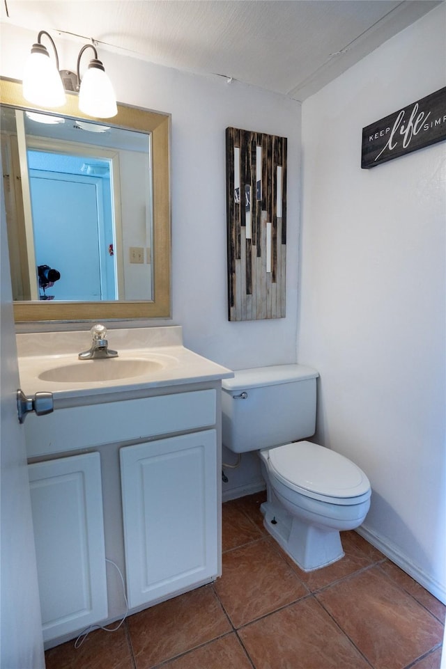 bathroom with tile patterned floors, vanity, and toilet