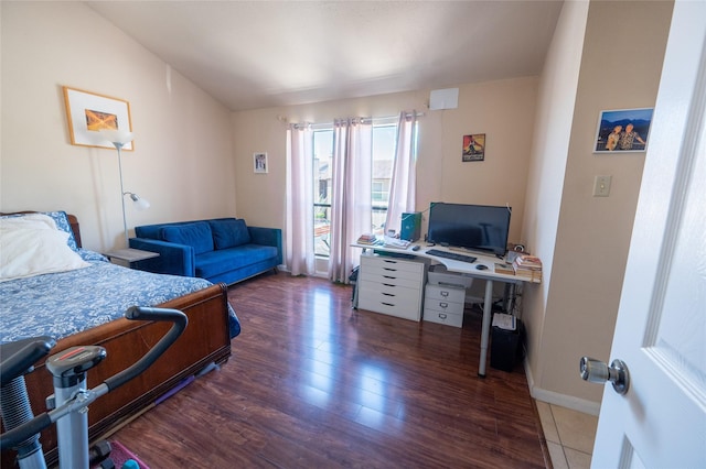 bedroom featuring wood finished floors and baseboards