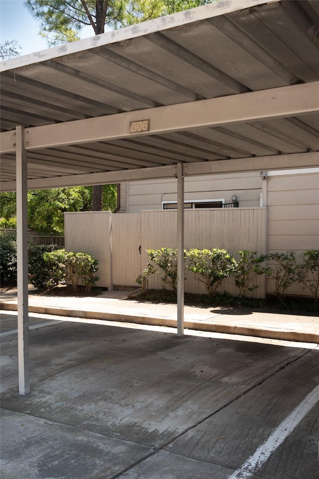covered parking lot with fence