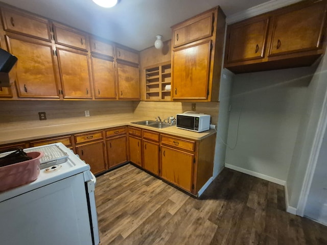 kitchen with a sink, brown cabinets, light countertops, white range with electric cooktop, and dark wood finished floors