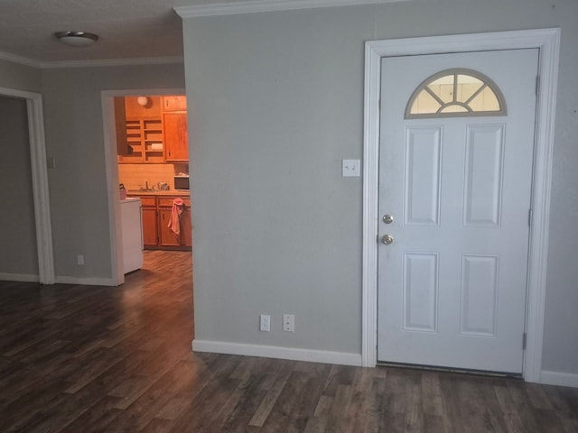 foyer entrance with dark wood-style floors, baseboards, and ornamental molding