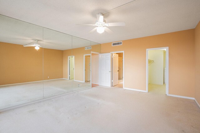 unfurnished bedroom featuring carpet flooring, visible vents, a closet, and baseboards