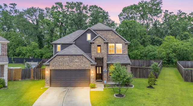view of front facade featuring concrete driveway, a front yard, brick siding, and a garage