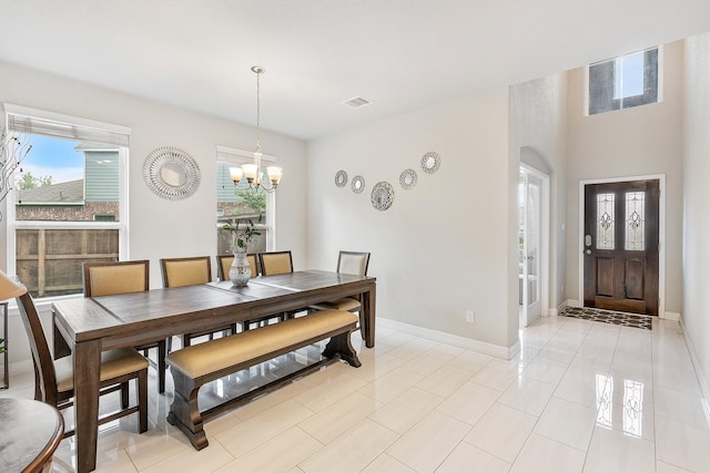 dining space with visible vents, an inviting chandelier, baseboards, and plenty of natural light