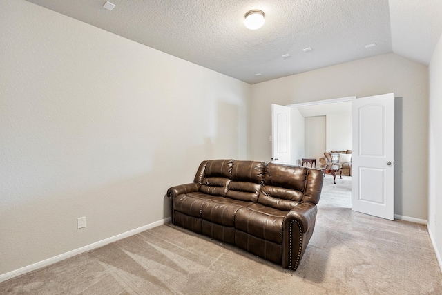 living area featuring a textured ceiling, light colored carpet, and baseboards