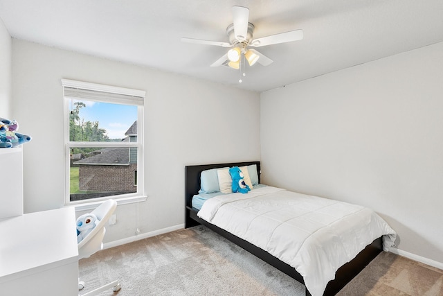 carpeted bedroom featuring a ceiling fan and baseboards