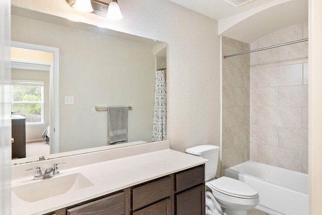 bathroom with toilet, shower / bath combo, and vanity
