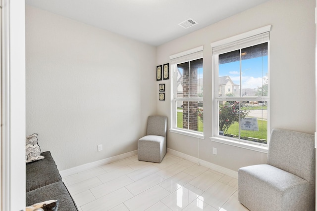 sitting room with visible vents and baseboards