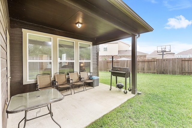 view of patio / terrace with a grill and fence