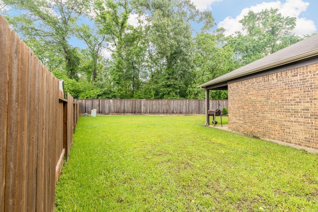 view of yard with a fenced backyard