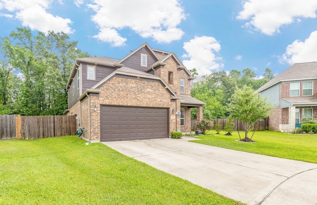 traditional-style home with driveway, an attached garage, fence, brick siding, and a front lawn