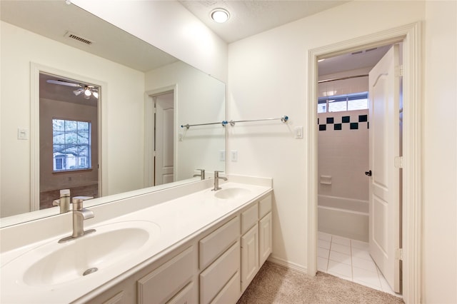 bathroom with visible vents, a sink, double vanity, and a wealth of natural light