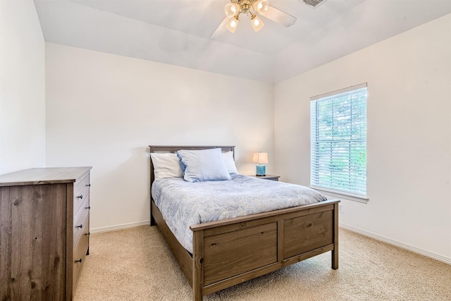 bedroom with a ceiling fan, baseboards, visible vents, and light carpet