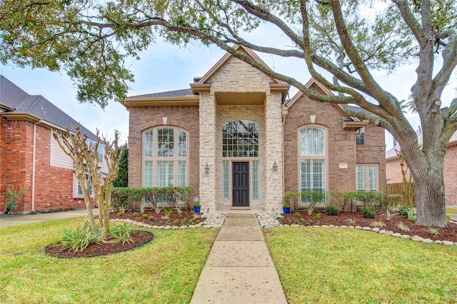 view of front of house with brick siding and a front yard