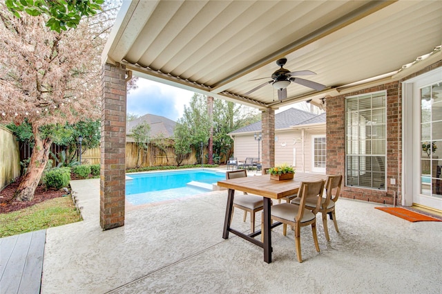 view of swimming pool with ceiling fan, outdoor dining area, a fenced in pool, a fenced backyard, and a patio