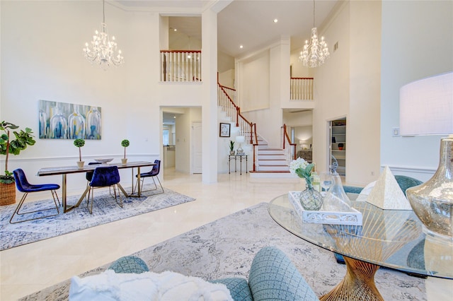 interior space featuring an inviting chandelier, a towering ceiling, and stairway