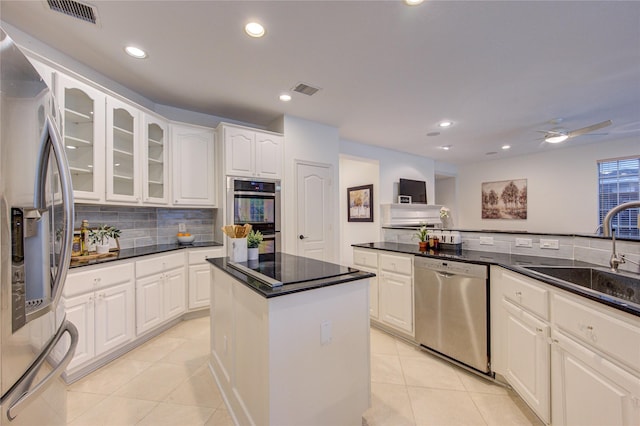 kitchen featuring a sink, stainless steel appliances, light tile patterned flooring, and visible vents