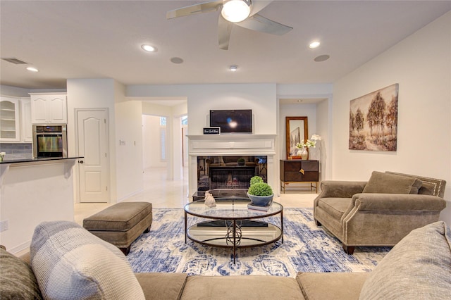 living room featuring ceiling fan, recessed lighting, and visible vents