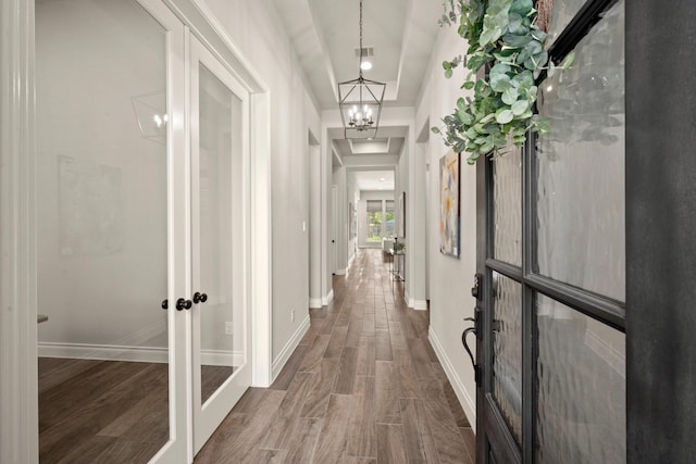 16711 Arboleda Dr, Humble, TX 77346 - hallway with french doors, a chandelier, dark wood-style floors, and baseboards