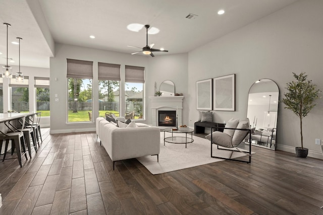 16711 Arboleda Dr, Humble, TX 77346 - living room featuring dark wood-style flooring, ceiling fan, recessed lighting, a glass covered fireplace, and baseboards