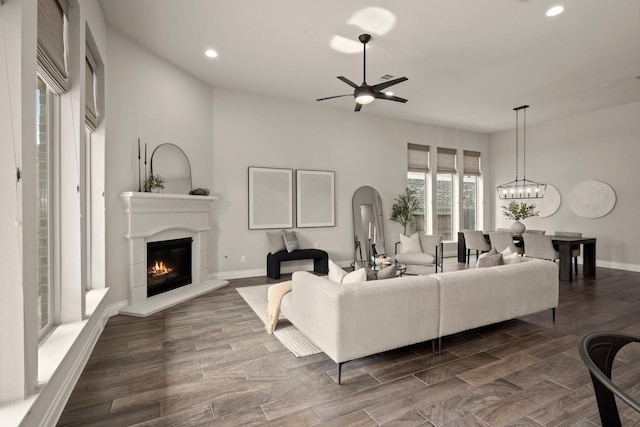 16711 Arboleda Dr, Humble, TX 77346 - living room with a ceiling fan, recessed lighting, a glass covered fireplace, baseboards, and arched walkways