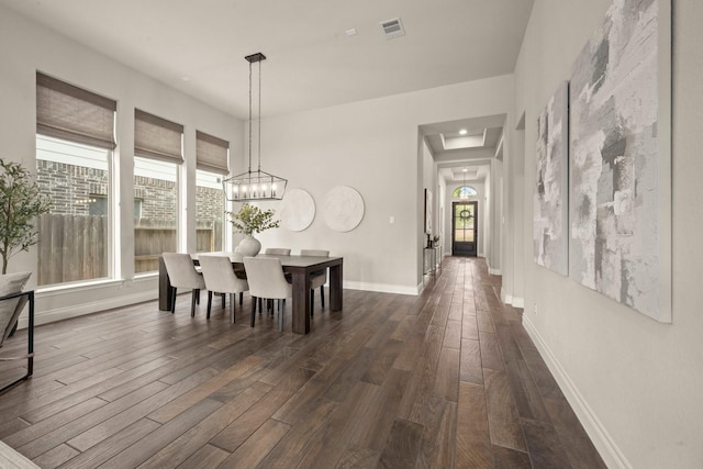 16711 Arboleda Dr, Humble, TX 77346 - dining room with dark wood-style flooring, plenty of natural light, baseboards, and a chandelier