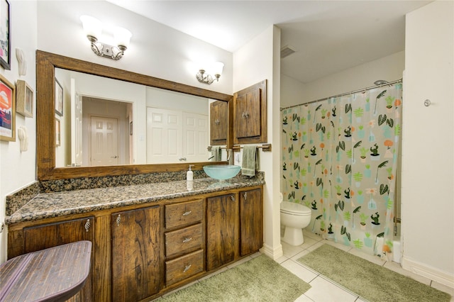 bathroom with a shower with curtain, tile patterned flooring, baseboards, vanity, and toilet