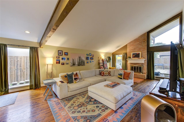 living area with a brick fireplace, dark wood-style flooring, and vaulted ceiling with beams