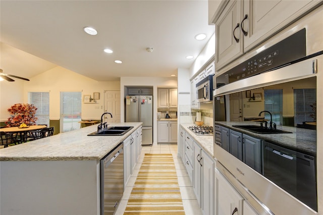 kitchen with a ceiling fan, appliances with stainless steel finishes, a sink, light tile patterned floors, and recessed lighting
