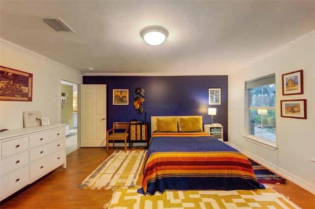 11815 Poplar Creek Dr, Houston, TX 77077 - bedroom featuring visible vents, ornamental molding, and wood finished floors