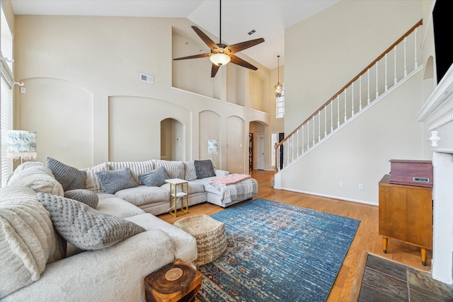 13907 Carrington Ln, Cypress, TX 77429 - living area with arched walkways, a ceiling fan, high vaulted ceiling, and wood finished floors