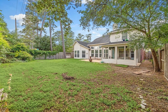 13907 Carrington Ln, Cypress, TX 77429 - back of property with a sunroom, a patio area, and roof with shingles