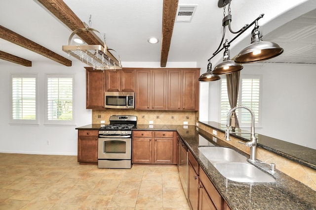 kitchen featuring tasteful backsplash, beamed ceiling, a sink, appliances with stainless steel finishes, and visible vents