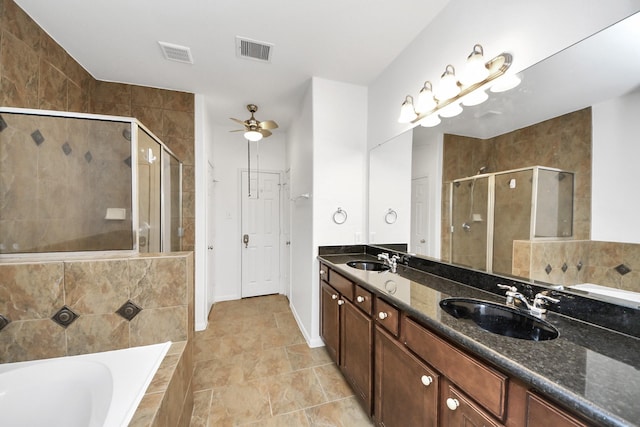 bathroom featuring visible vents, a stall shower, and a sink