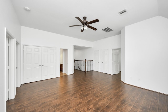 unfurnished living room featuring dark wood-style floors, a ceiling fan, and visible vents