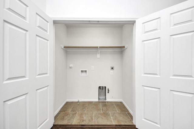 washroom with gas dryer hookup, hookup for a washing machine, laundry area, and baseboards