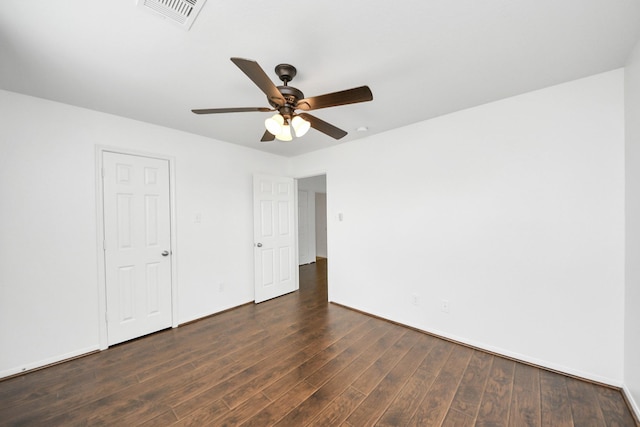 unfurnished bedroom with a ceiling fan, visible vents, wood finished floors, and baseboards
