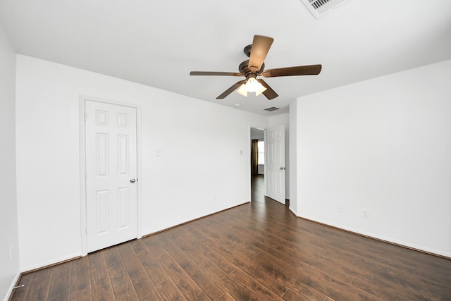 unfurnished room featuring a ceiling fan, visible vents, and dark wood-style flooring
