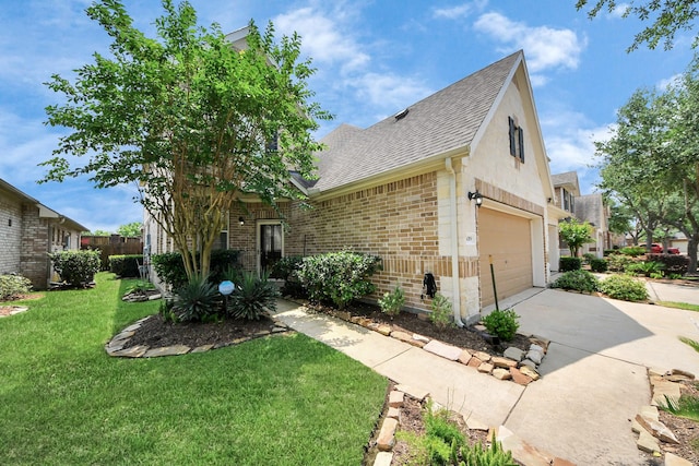 view of front of home with brick siding, roof with shingles, a front lawn, concrete driveway, and an attached garage