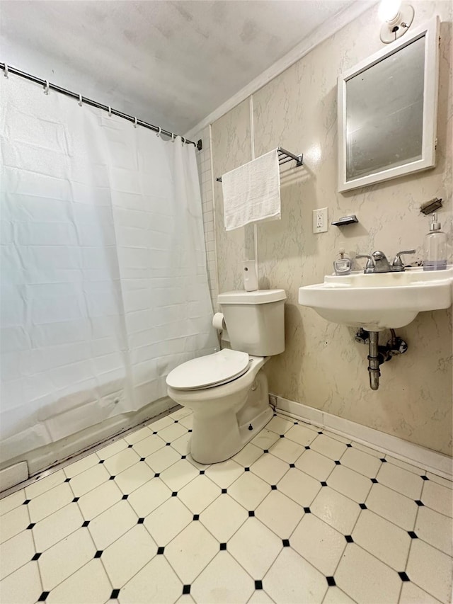 bathroom featuring tile patterned floors, toilet, and shower / bath combo with shower curtain