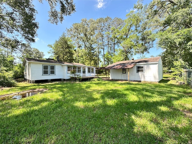 rear view of house with a lawn