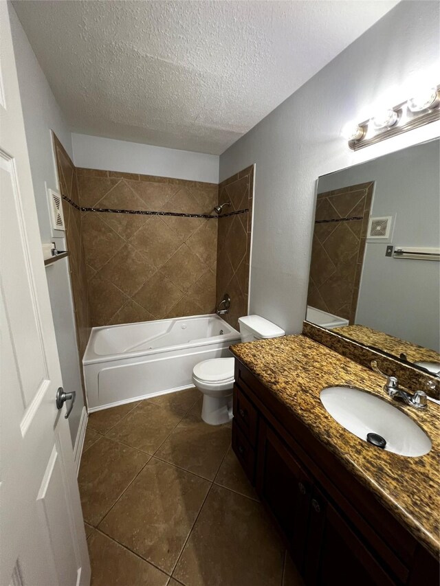 full bath featuring a textured ceiling, toilet, vanity,  shower combination, and tile patterned flooring