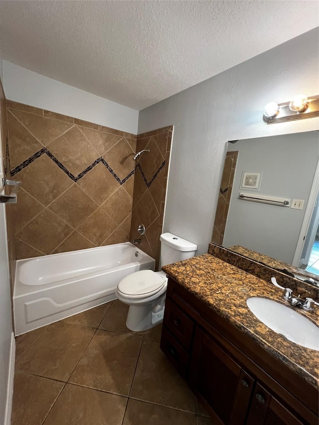 bathroom featuring tile patterned flooring, toilet, vanity, a textured ceiling, and tub / shower combination