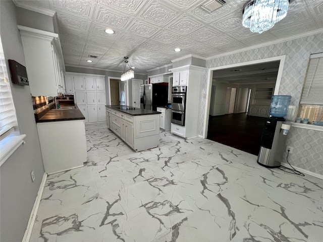 16418 York Minster Dr, Spring, TX 77379 - kitchen featuring a chandelier, crown molding, baseboards, a sink, and white cabinetry