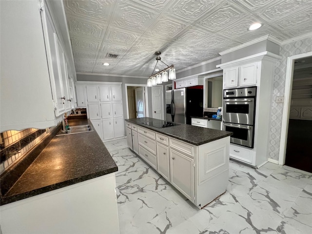 16418 York Minster Dr, Spring, TX 77379 - kitchen featuring appliances with stainless steel finishes, a sink, a center island, white cabinetry, and light marble finish flooring