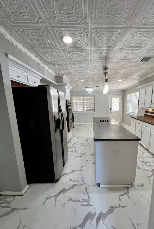 16418 York Minster Dr, Spring, TX 77379 - kitchen featuring appliances with stainless steel finishes, dark countertops, a kitchen island, an ornate ceiling, and white cabinetry
