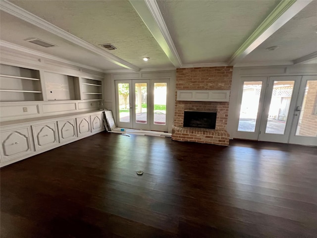 16418 York Minster Dr, Spring, TX 77379 - unfurnished living room with french doors, crown molding, healthy amount of natural light, dark wood-style flooring, and a textured ceiling