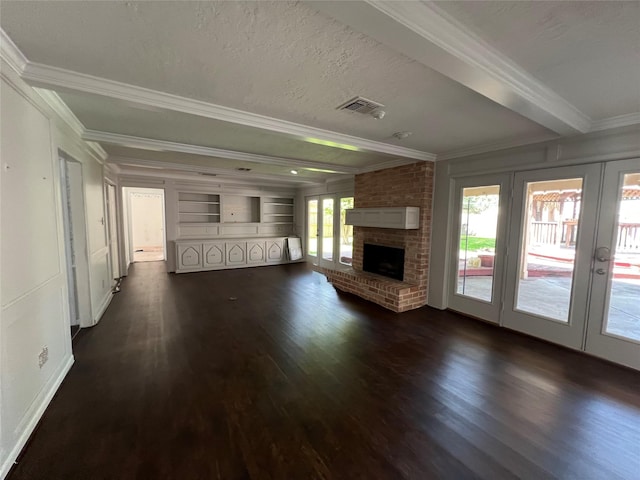 16418 York Minster Dr, Spring, TX 77379 - unfurnished living room with ornamental molding, french doors, dark wood-style floors, a brick fireplace, and baseboards