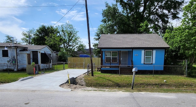 1085 Ellington St, Houston, TX 77088 - bungalow-style house featuring a fenced front yard, concrete driveway, a shingled roof, and covered porch