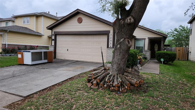 view of front facade featuring a front lawn, brick siding, concrete driveway, an attached garage, and fence